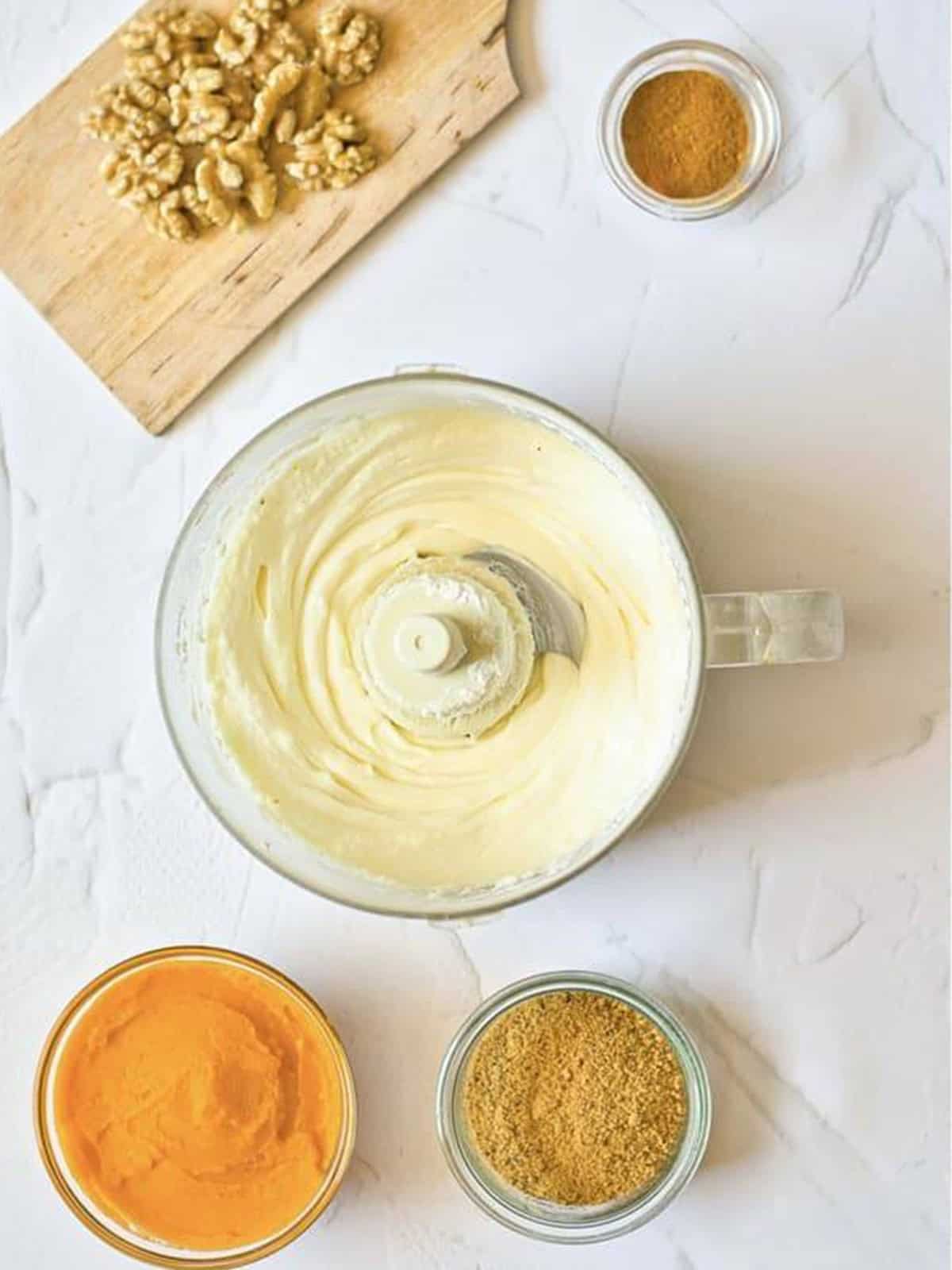 Cream cheese, sugar, and cornstarch blended smooth in a food processor.