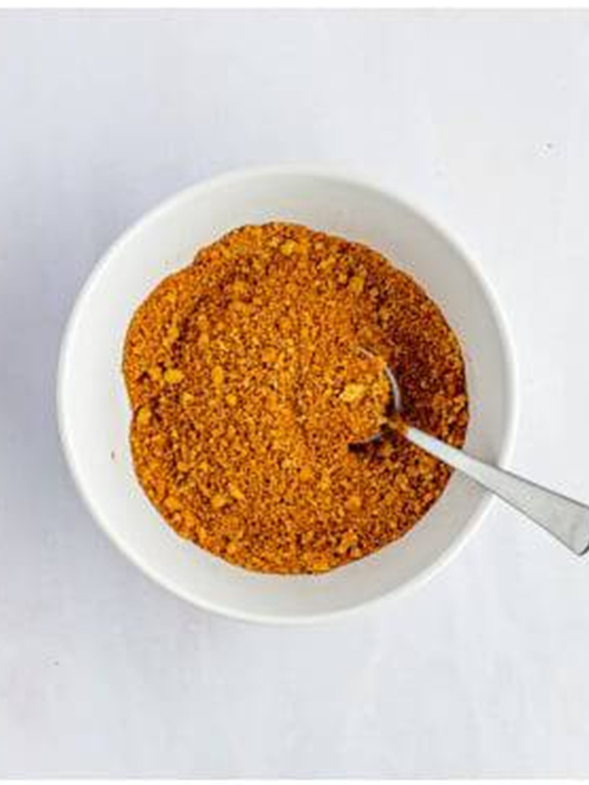 Pumpkin, brown sugar, and cinnamon mixed into a spiced filling in a bowl.