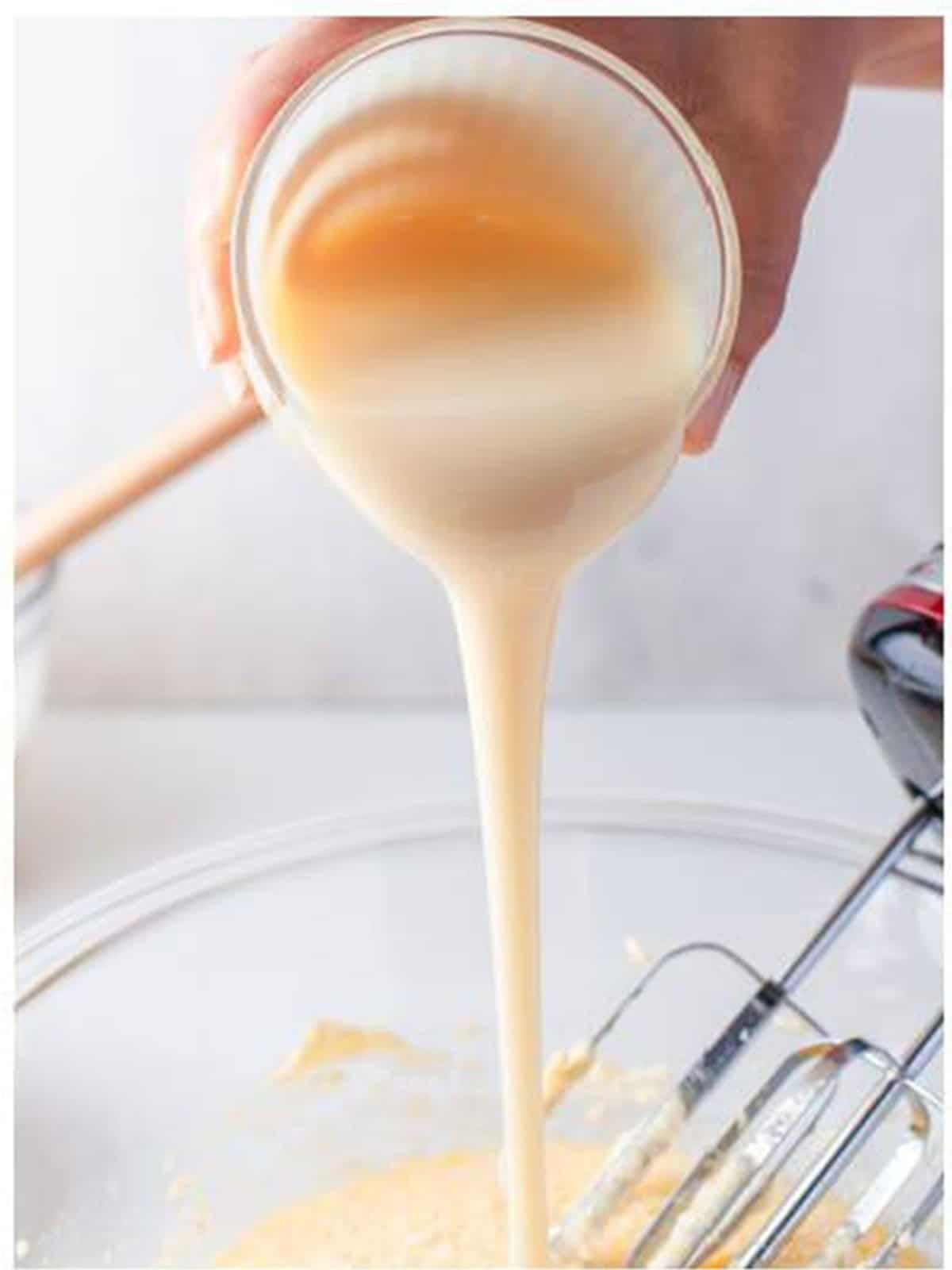 Sweetened condensed milk poured into the Pumpkin Cornbread batter.