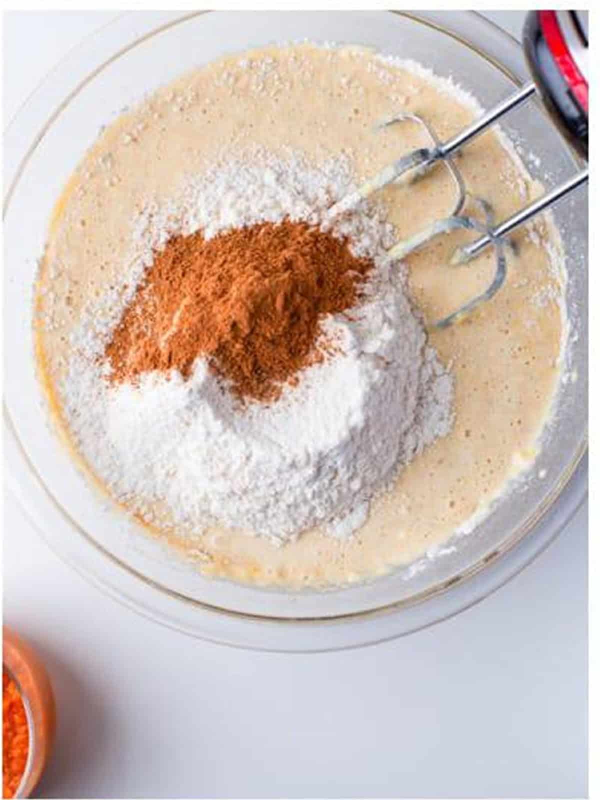Flour, baking powder, cinnamon, and pumpkin pie spice added to the batter.
