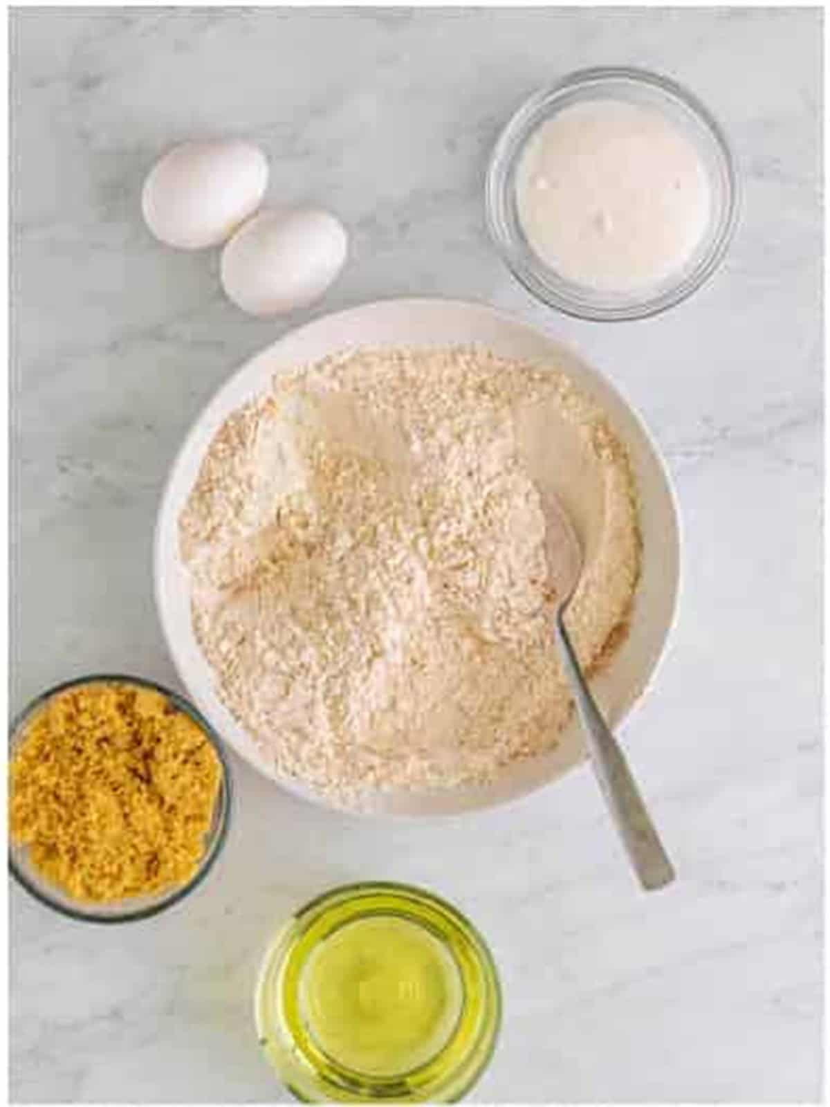 Whisking the flour, baking powder, pumpkin pie spice, baking soda, cinnamon, and salt together in a bowl for pumpkin cupcakes.