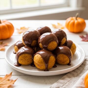 A plate of chocolate glazed Pumpkin Donut Holes.