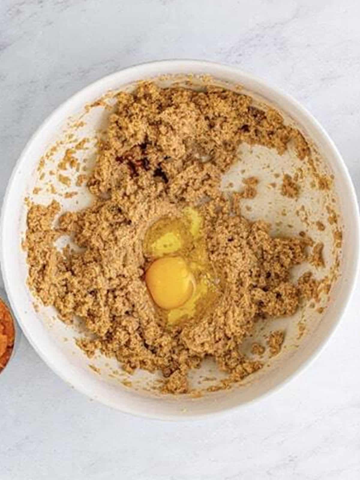 Egg added to the creamed butter and sugar mixture.
