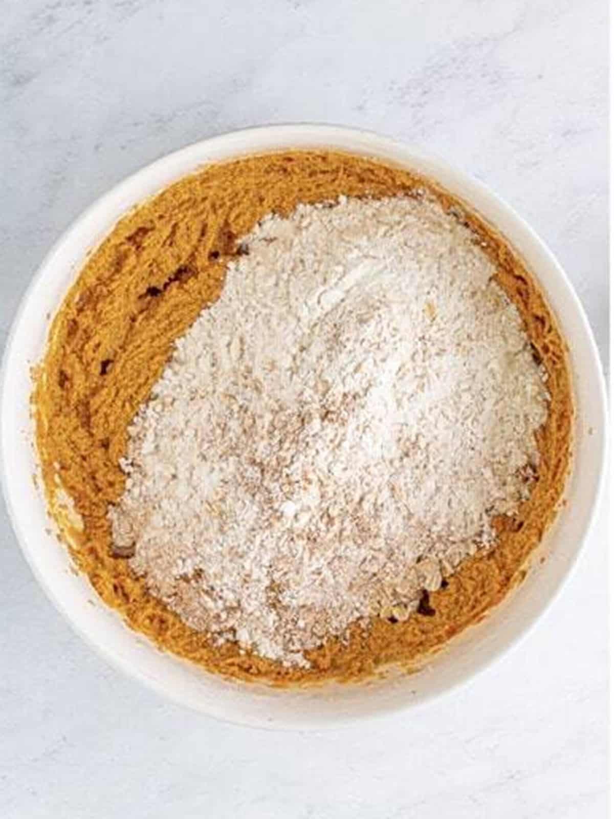 Dry ingredients and oats added to the Pumpkin Oatmeal Cookies dough.