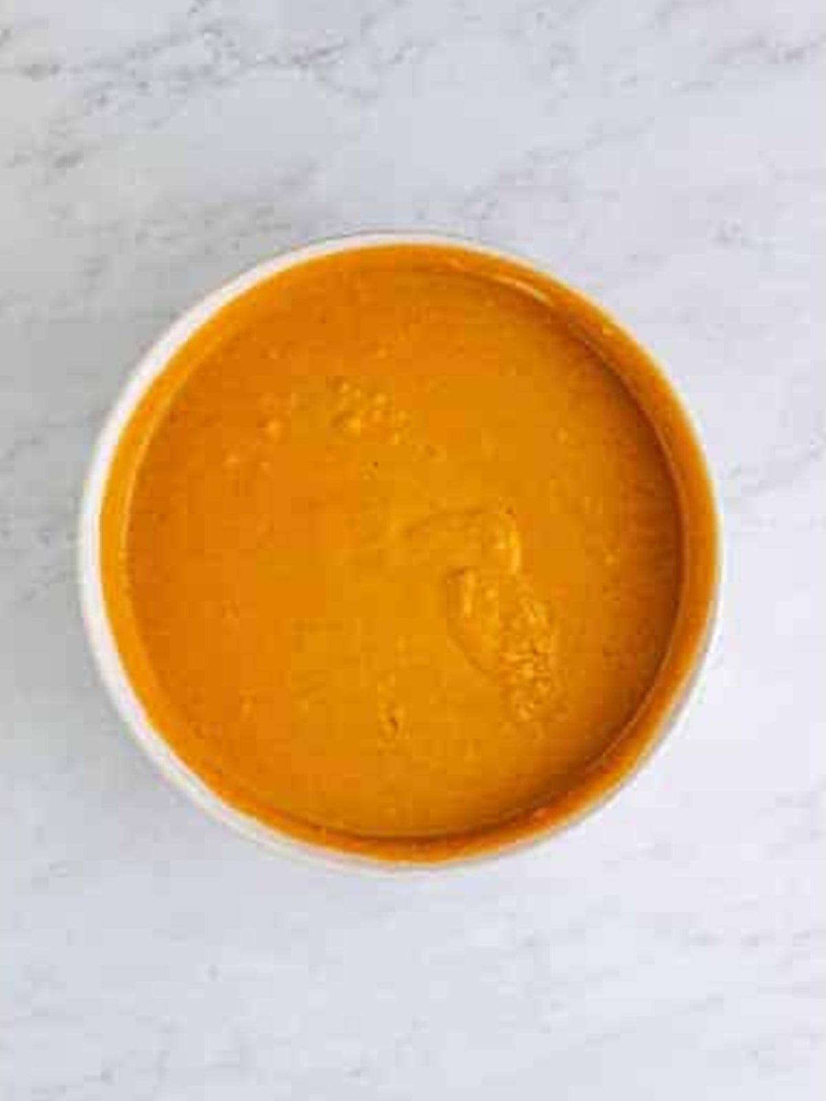 Pumpkin slab pie filling whisked completely smooth in a mixing bowl.
