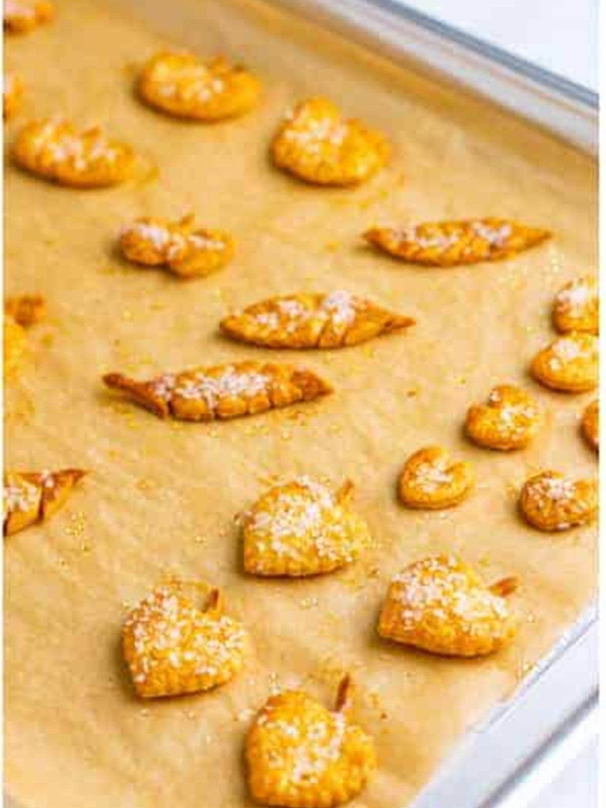 Golden baked pie crust leaf and pumpkin decorations for garnishing pumpkin slab pie.