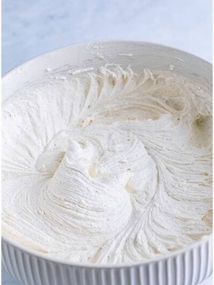 Fluffy marshmallow filling whipped smooth in a white bowl for Pumpkin Whoopie Pies.