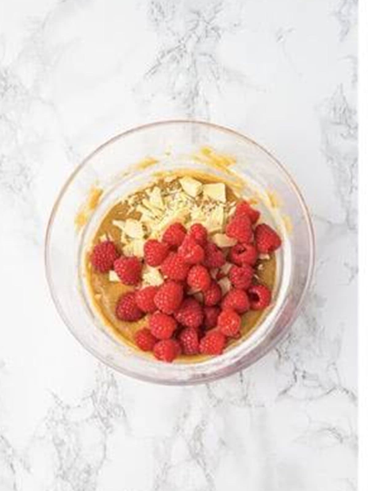 Fresh raspberries added on top of the white chocolate batter for raspberry brownies.