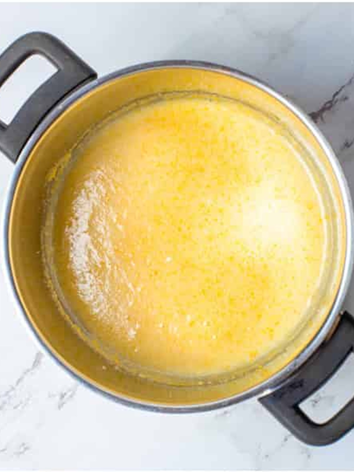 Sugar and egg yolks whisked together until smooth in a small saucepan for Raspberry Curd.