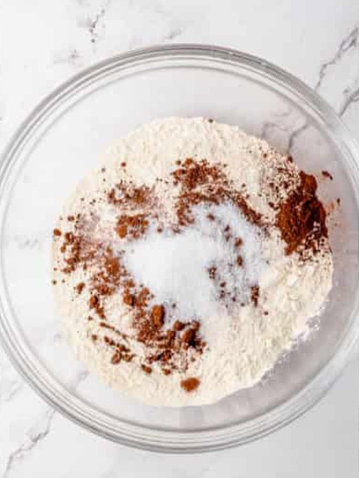 Bisquick mix, sugar, and cocoa powder whisked together in a glass bowl.