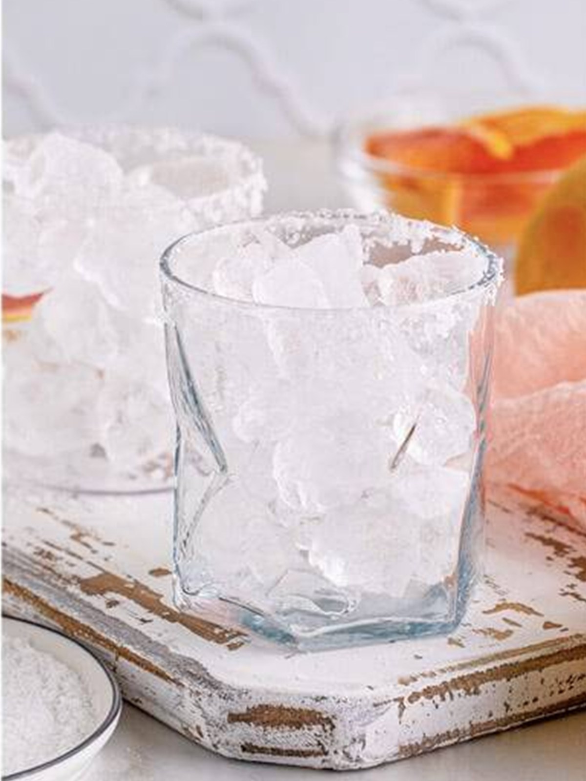Filling the salt-rimmed glass with ice for a salty dog cocktail.