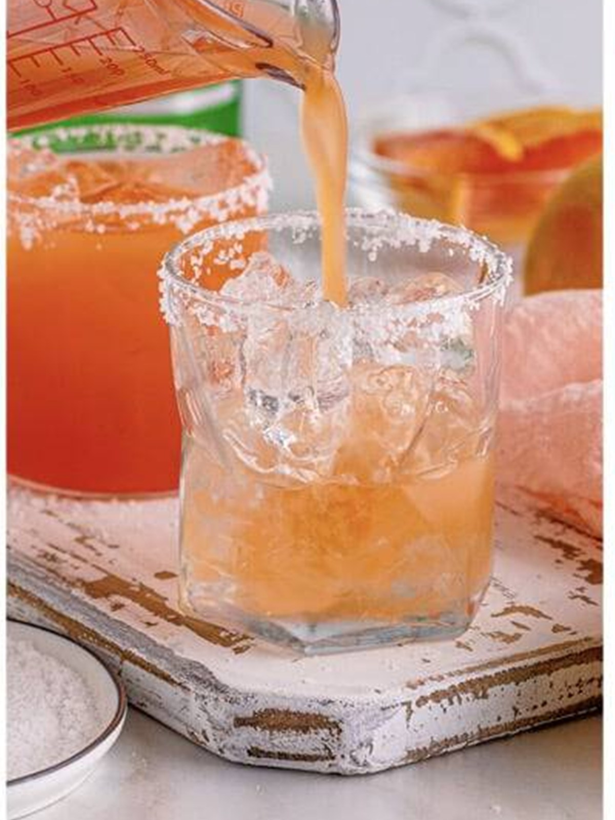 Pouring fresh grapefruit juice into the glass to make a salty dog.