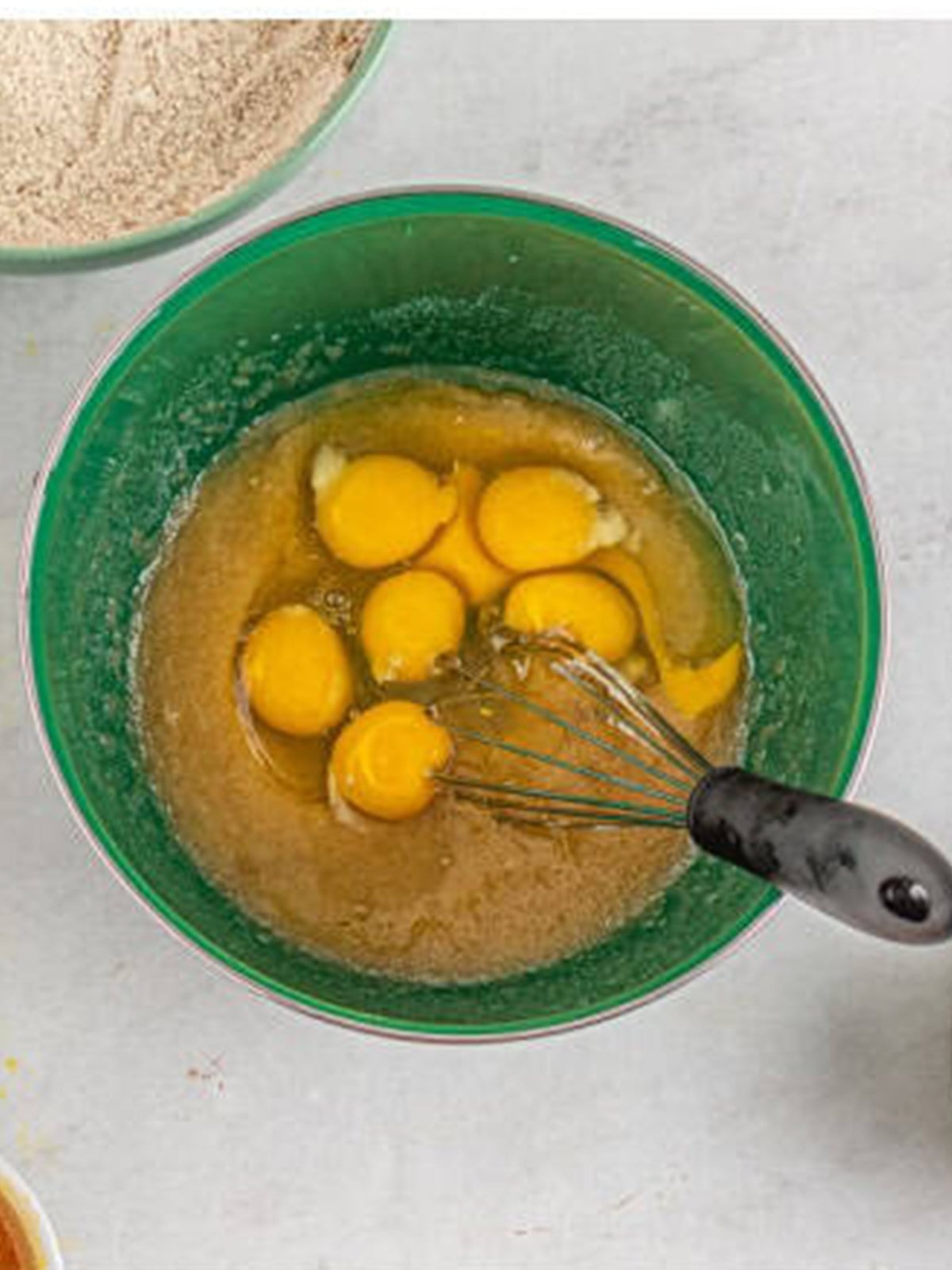 Eggs added to the wet ingredients for spiced bundt cake batter.
