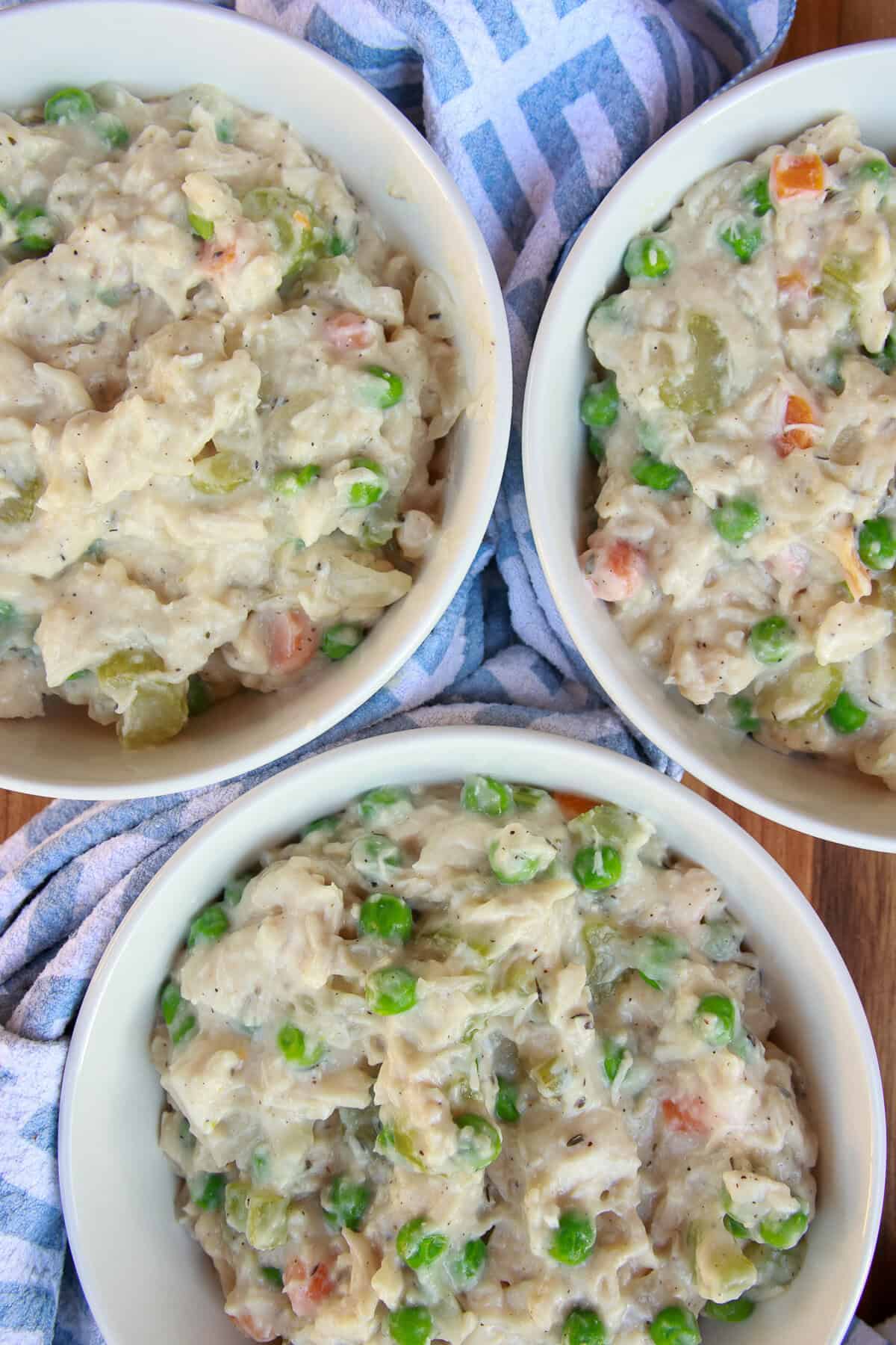 Cheesy chicken pot pie filling divided between two oven safe baking dishes.