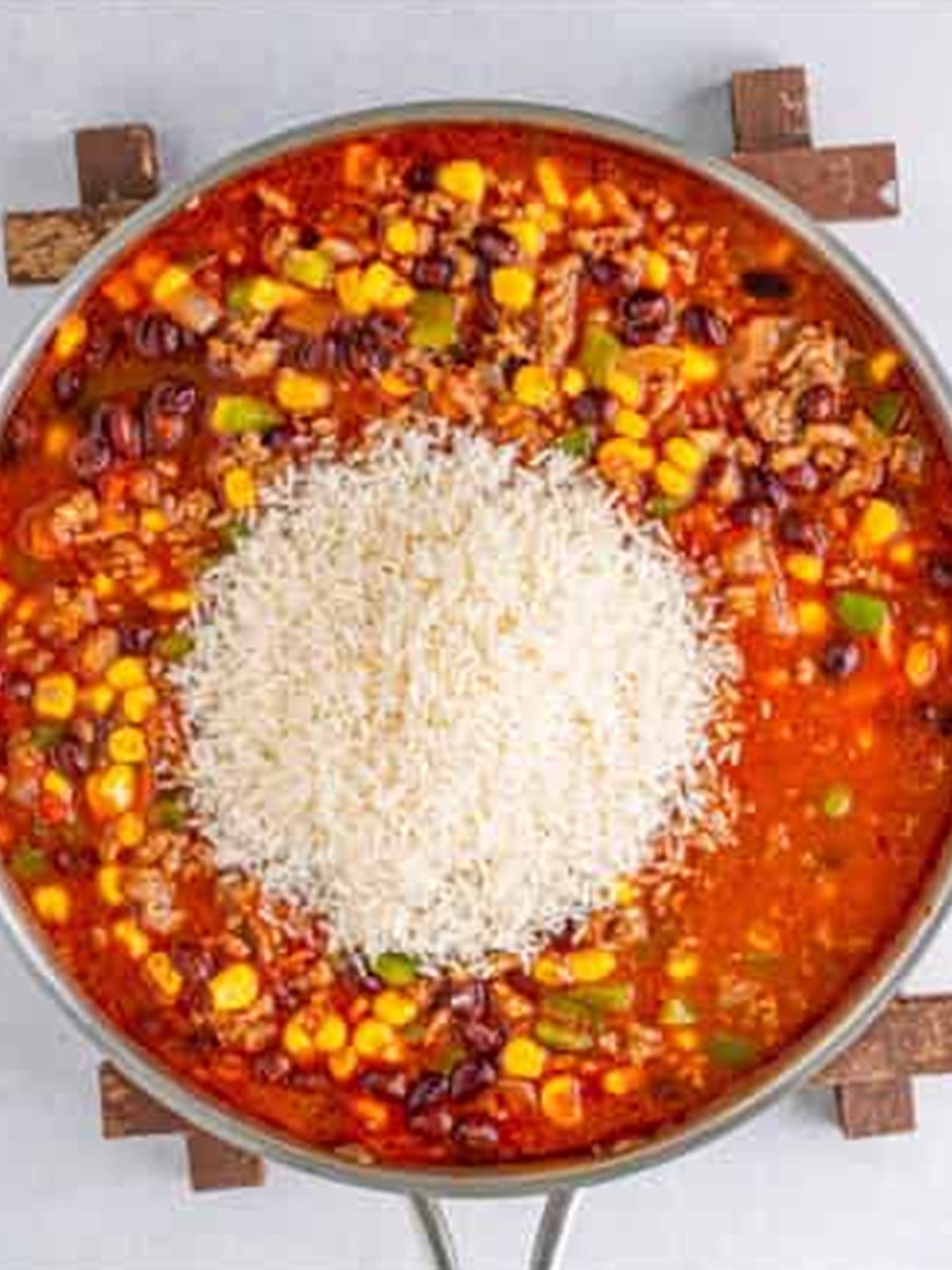 White rice stirred into the Mexican rice casserole mixture