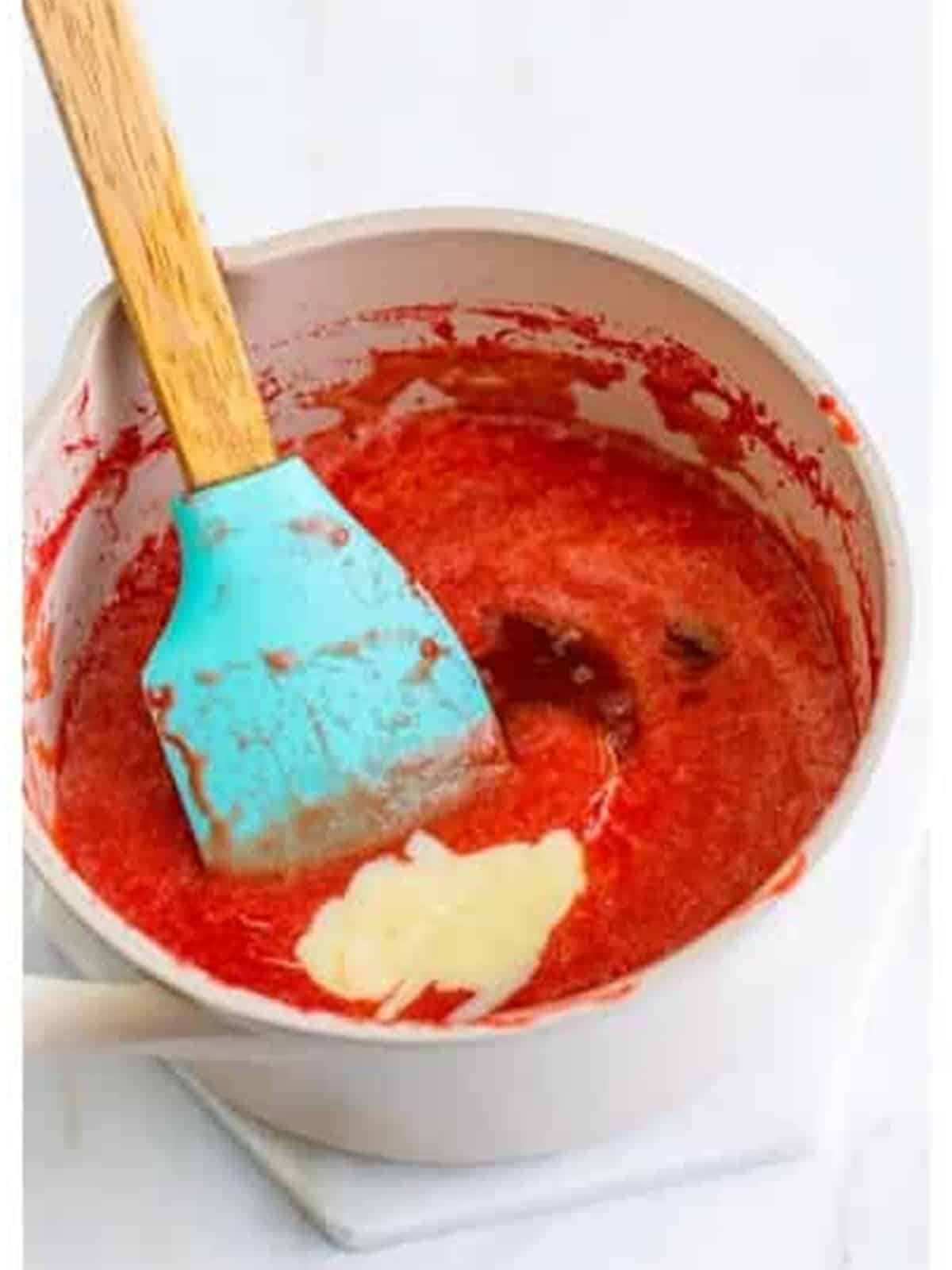 Sweetened condensed milk and vanilla whisked into the reduced strawberry puree for Strawberry Ice Cream.