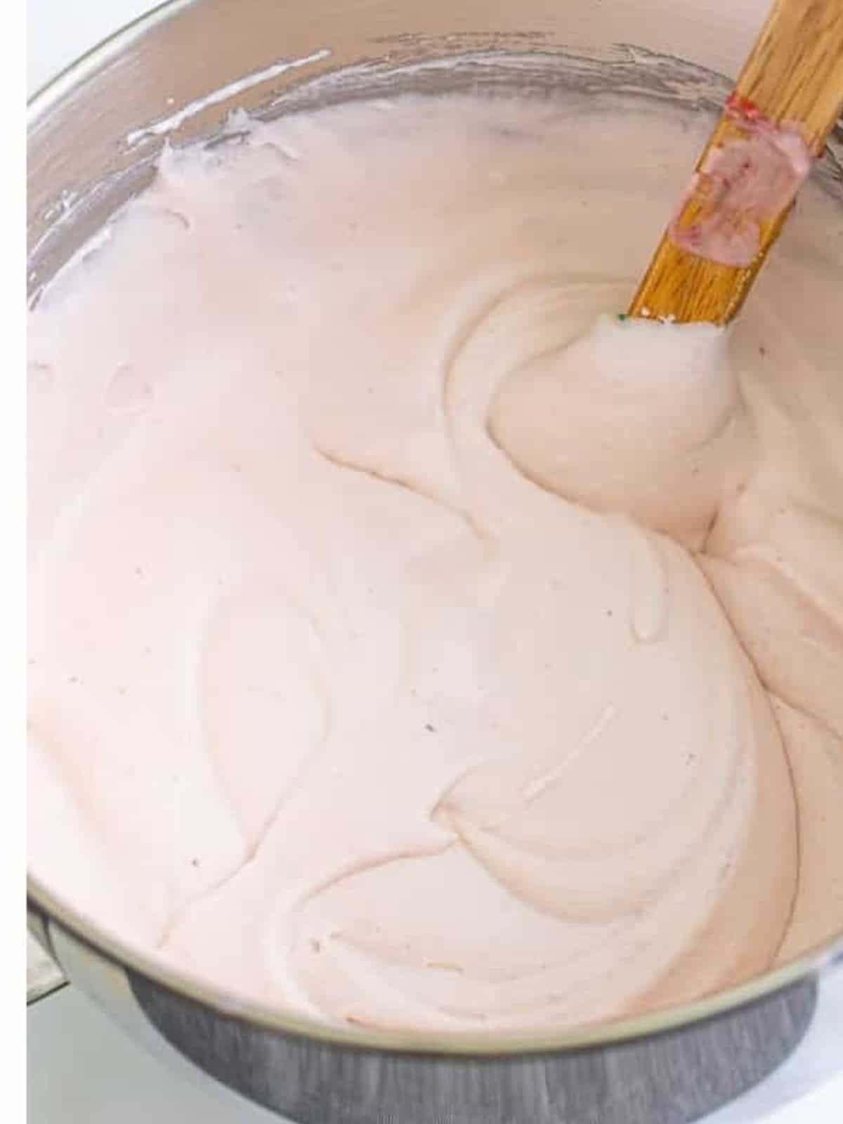 Smooth pink Strawberry Ice Cream base ready to pour into a loaf pan and freeze.