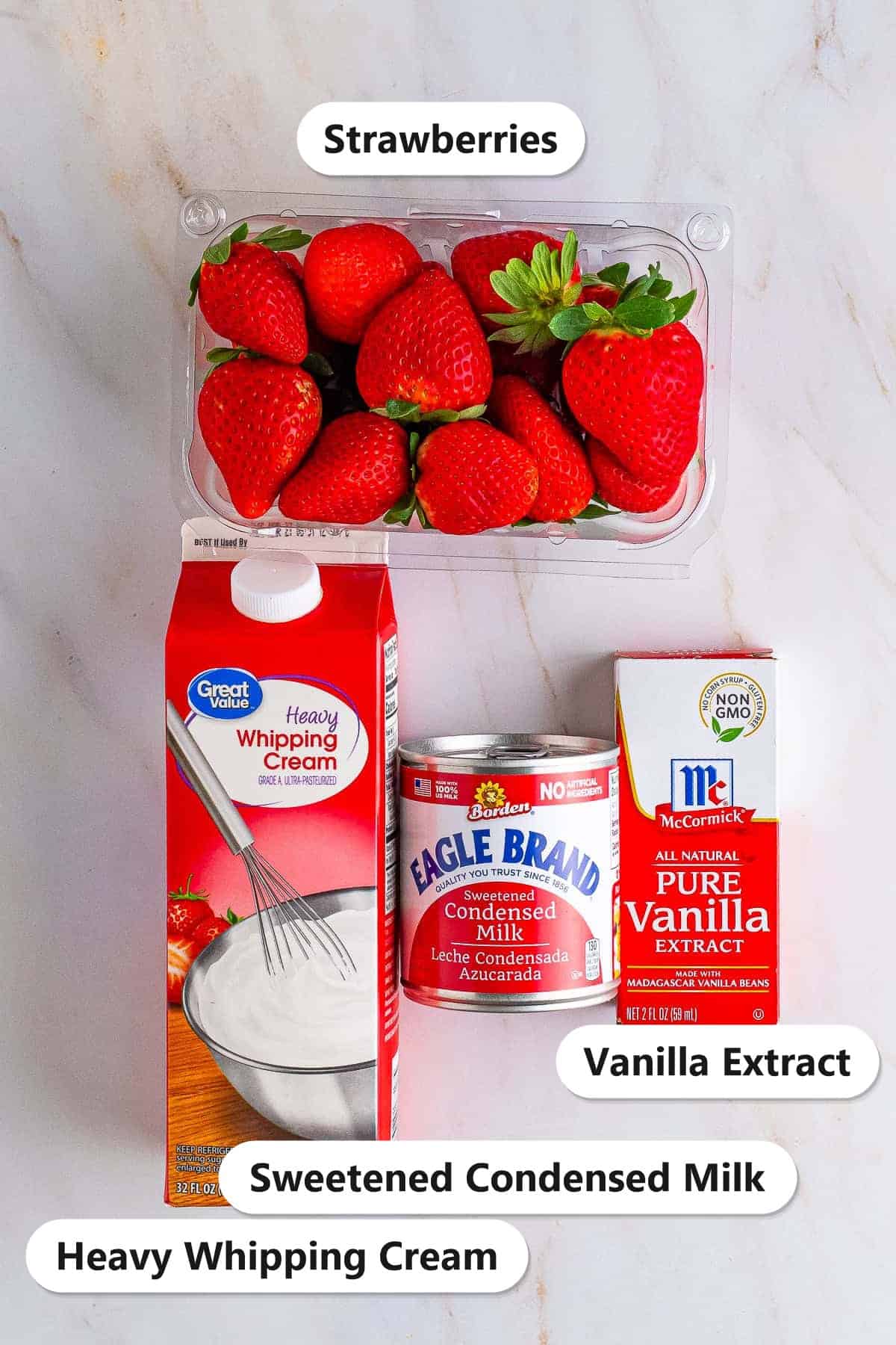Labeled ingredients for Strawberry Ice Cream: fresh strawberries, heavy whipping cream, sweetened condensed milk, and vanilla extract.