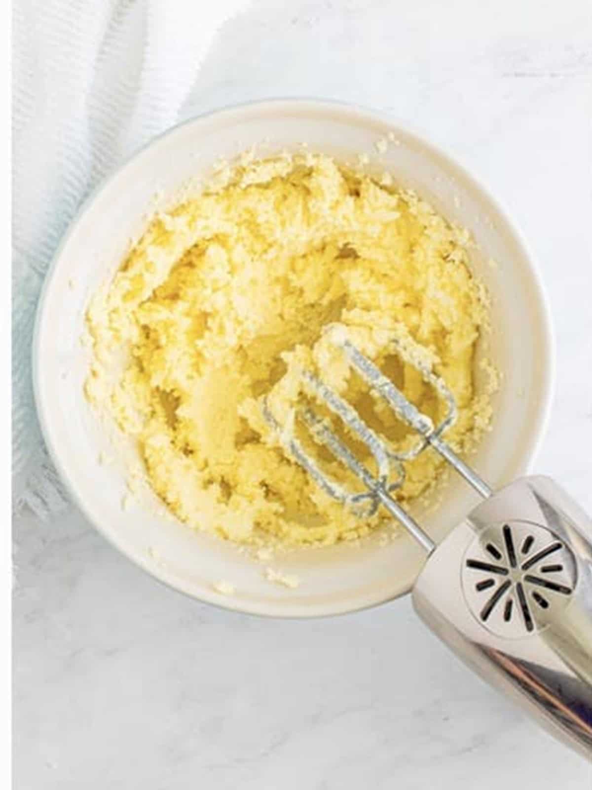 Butter and sugar creamed together in a bowl for sugar cookie bars.
