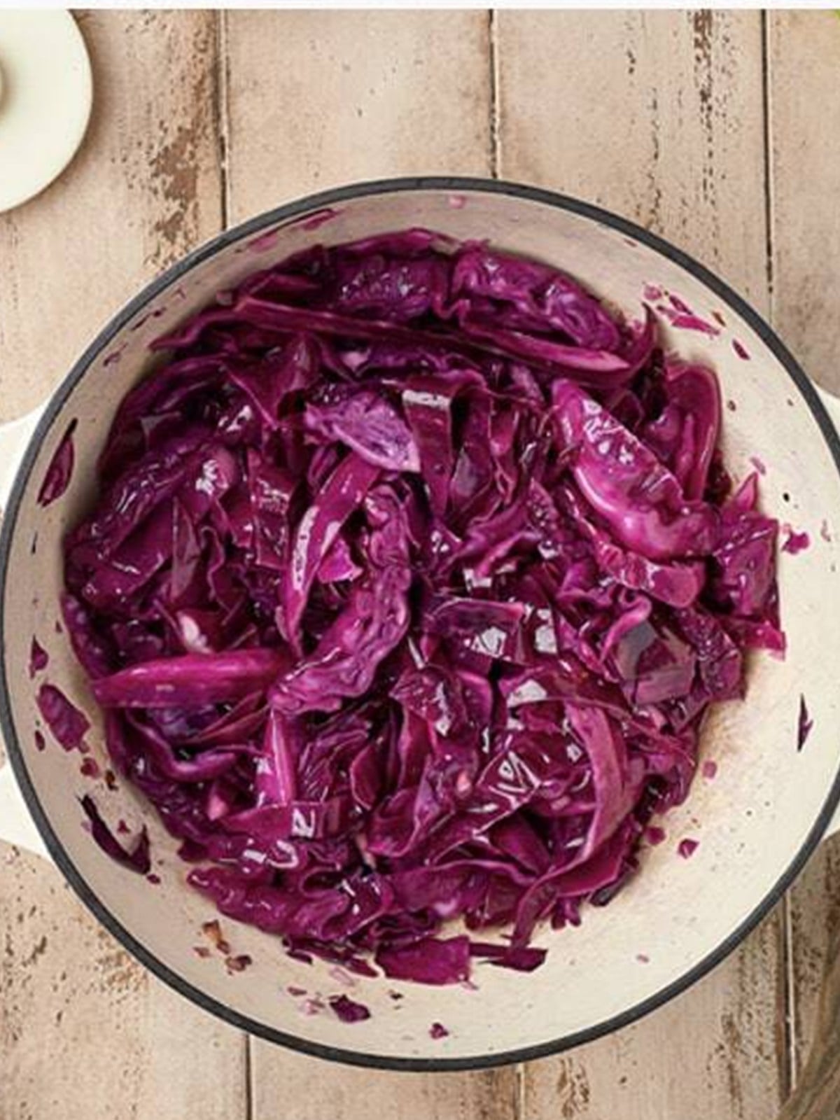 Red cabbage simmered until tender in a pot for sweet and sour cabbage.
