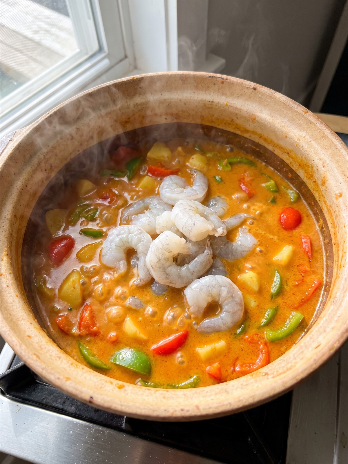 Shrimp added to the simmering coconut curry.