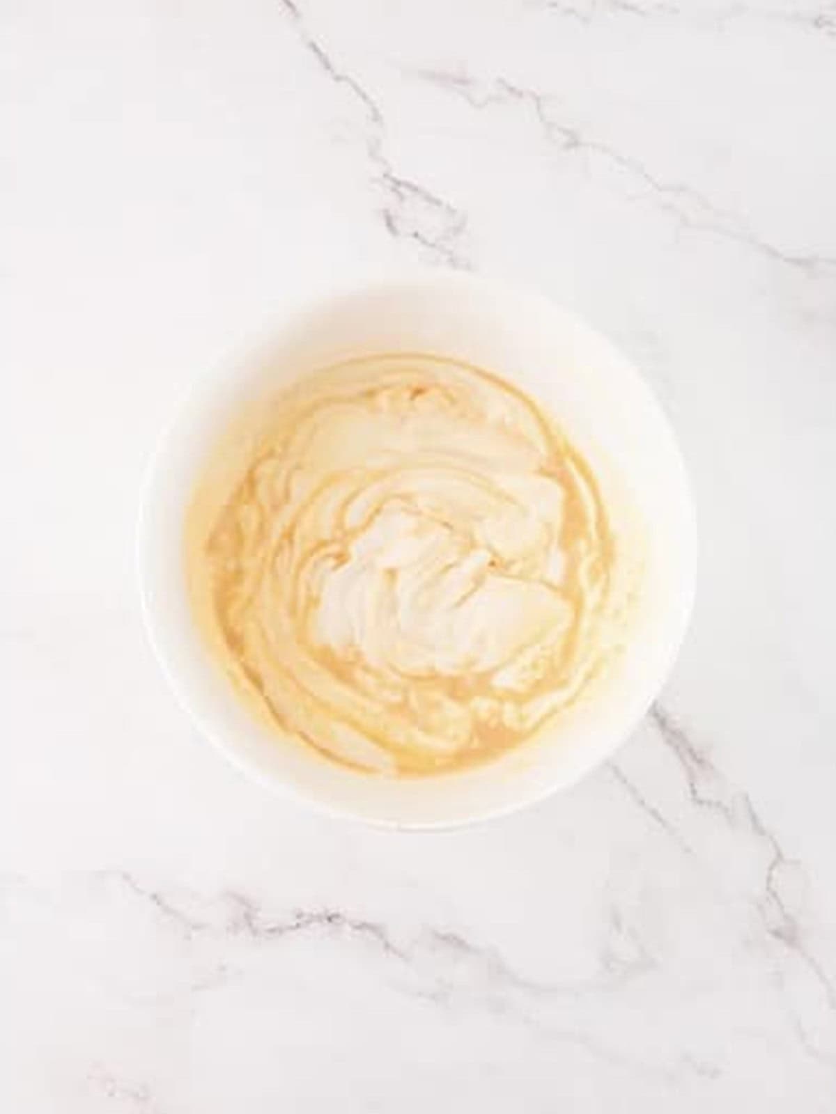 Folding mascarpone and coffee liqueur into the whipped cream for Tiramisu French Toast.