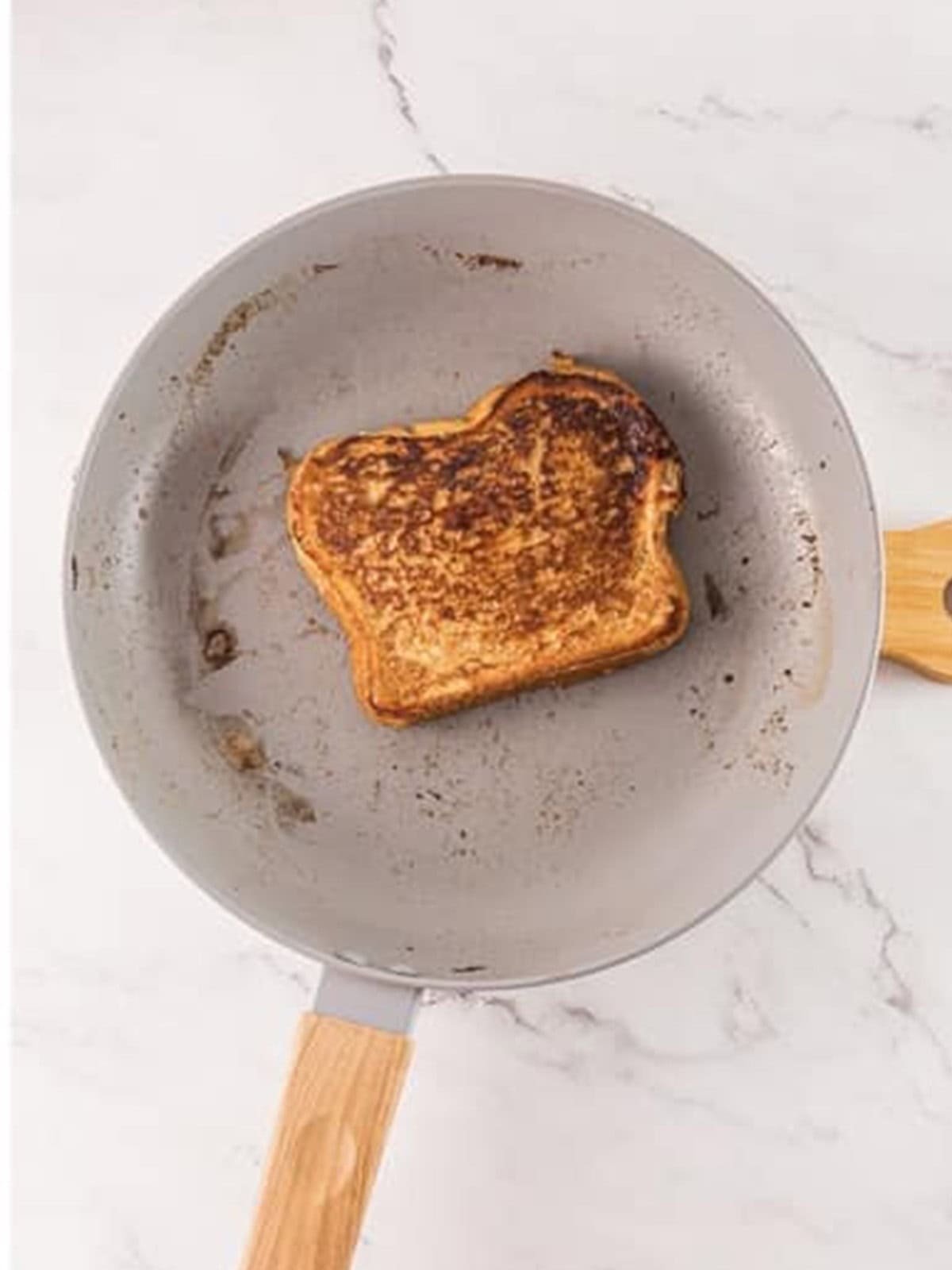 Cooking Tiramisu French Toast until golden brown on both sides in the pan.