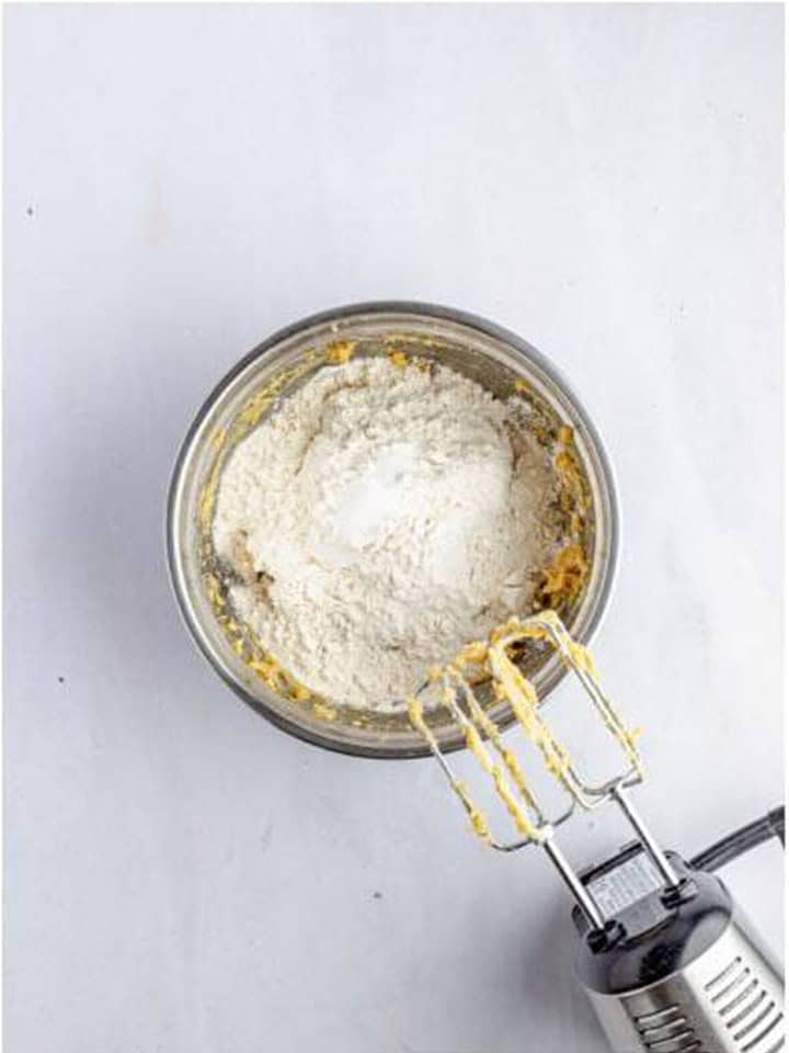 Flour and salt added on top of the creamed butter mixture for toffee bar dough.