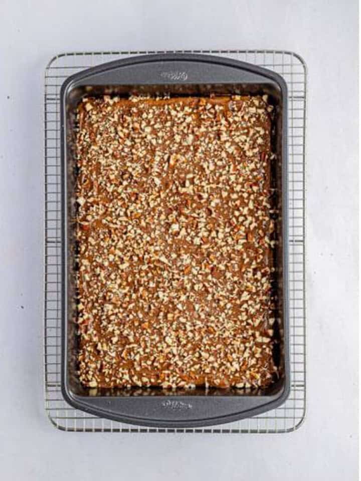 Chopped pecans sprinkled over the melted chocolate layer on toffee bars.