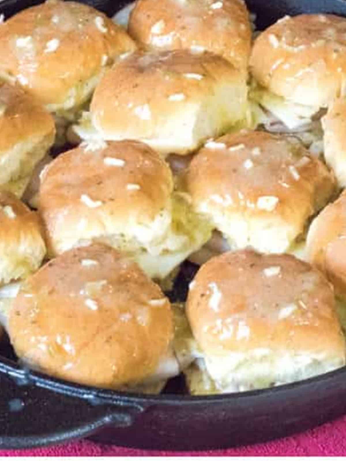 Baked turkey sliders in the skillet with golden brown buttered tops.