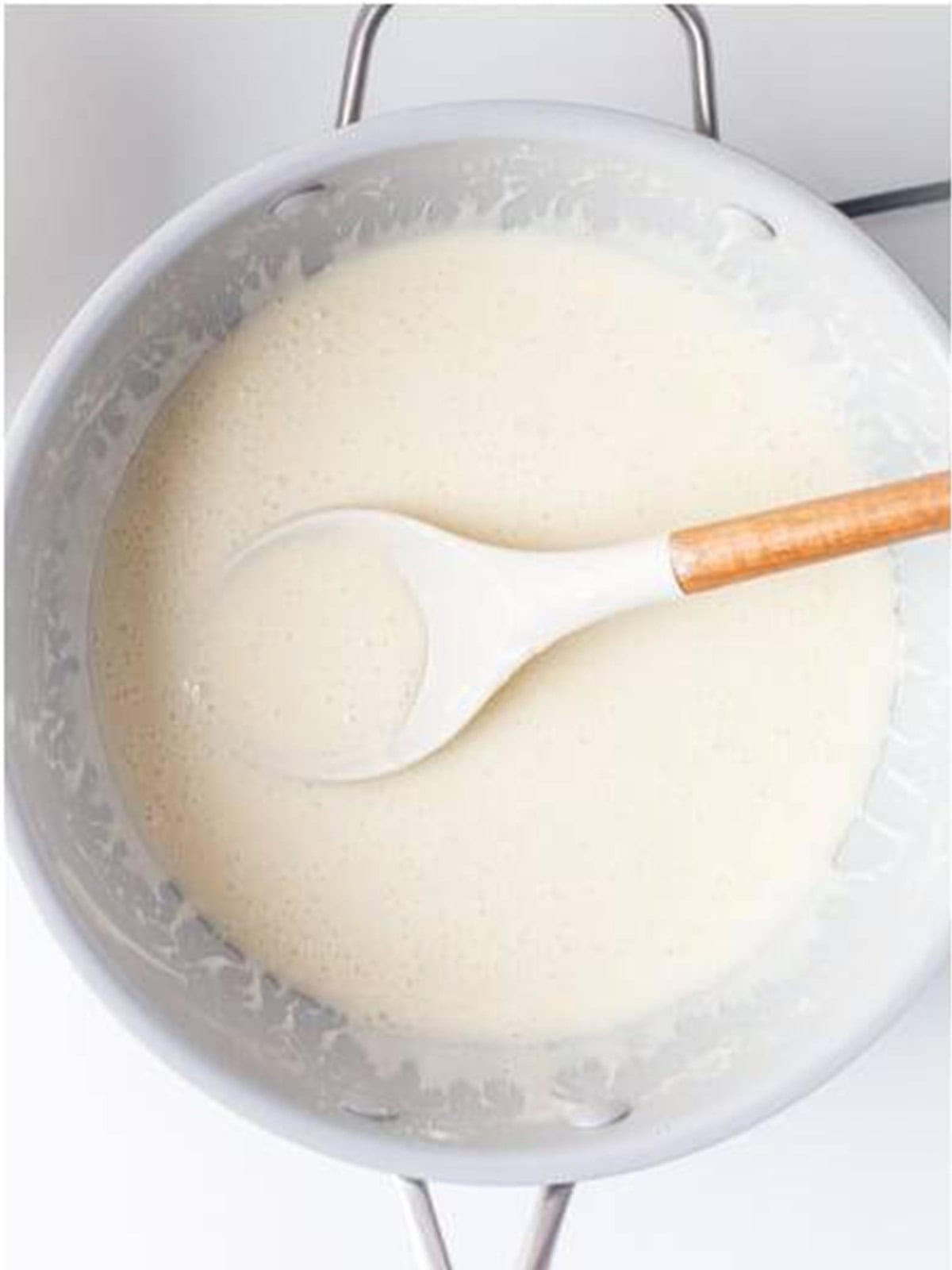 Butter and mini marshmallows melted together into a smooth mixture in a large saucepan.