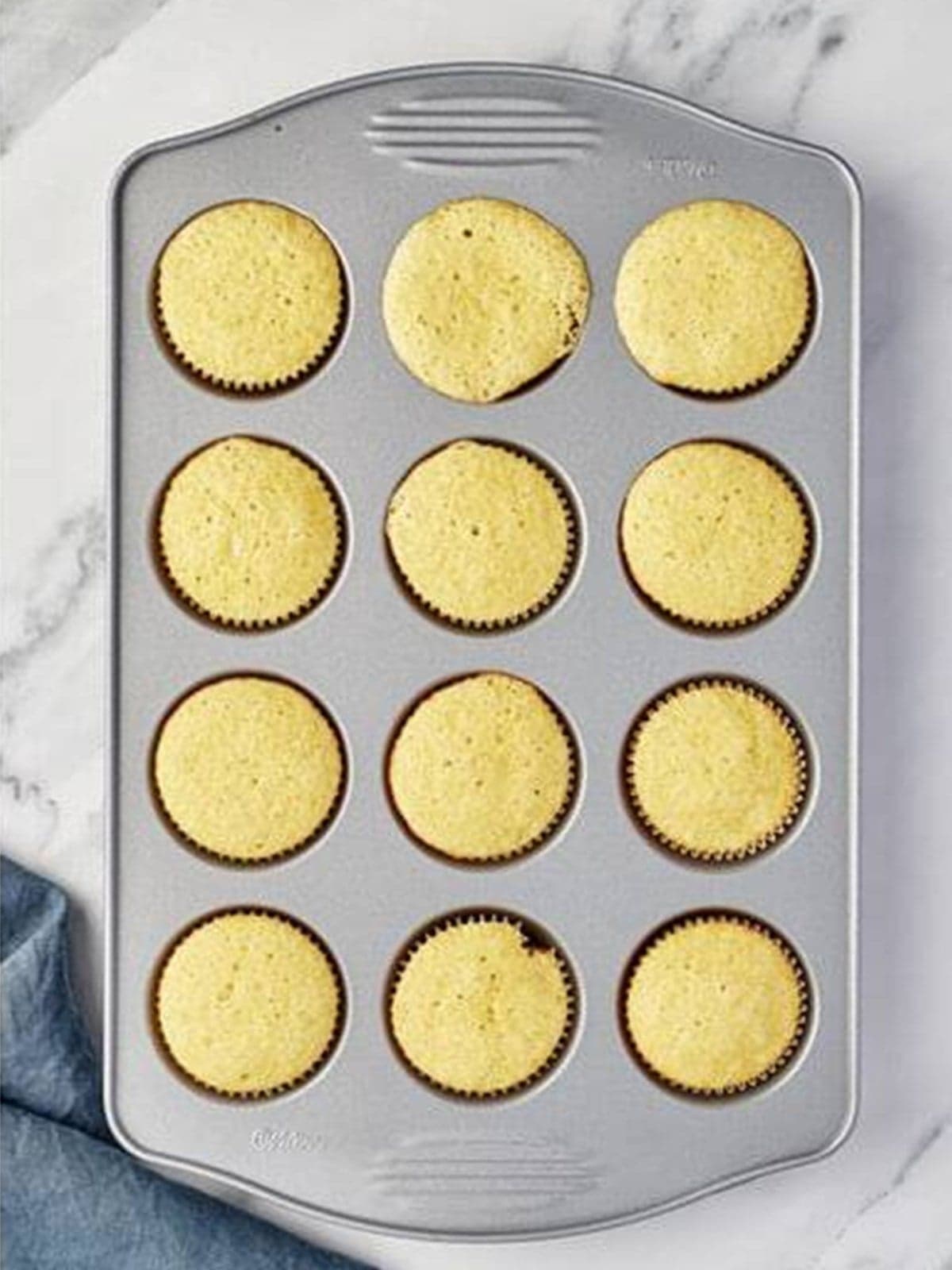 Baked vanilla cupcakes cooling in the pan for Valentines Day Cupcakes.