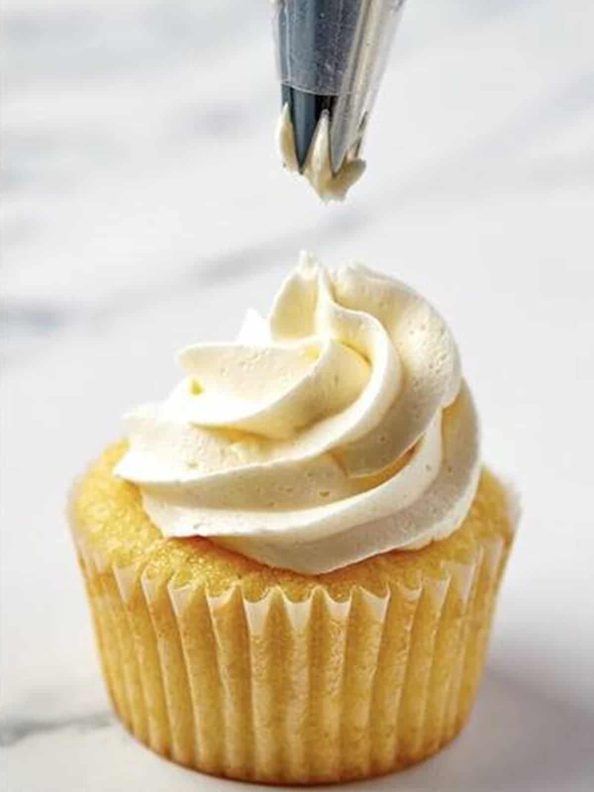 Buttercream frosting piped in a swirl on top of a Valentines Day Cupcake.