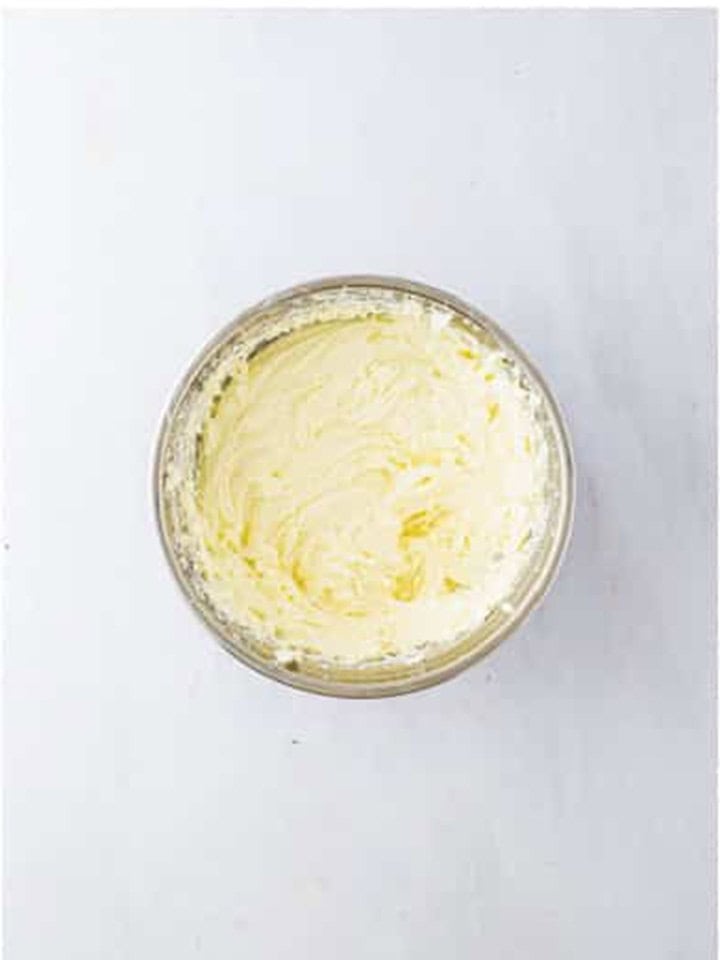 Cream cheese whipped smooth with sugar in the springform bowl for cheesecake filling.