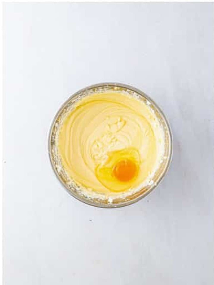 An egg added to the cheesecake filling to be mixed in one at a time.