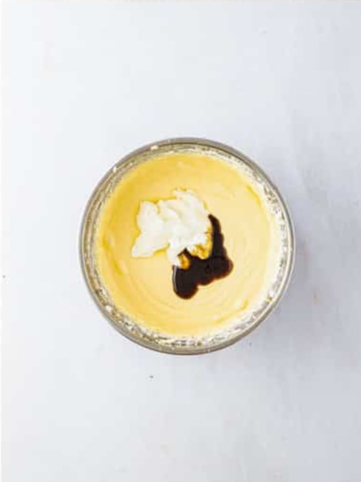 Sour cream and vanilla bean paste added on top of the smooth cheesecake filling.