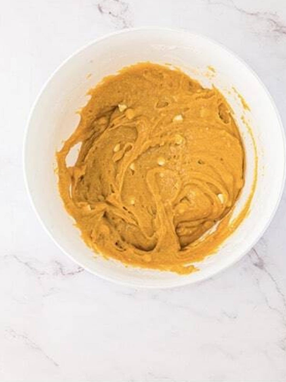White chocolate chips stirred into the thick golden blondie batter.