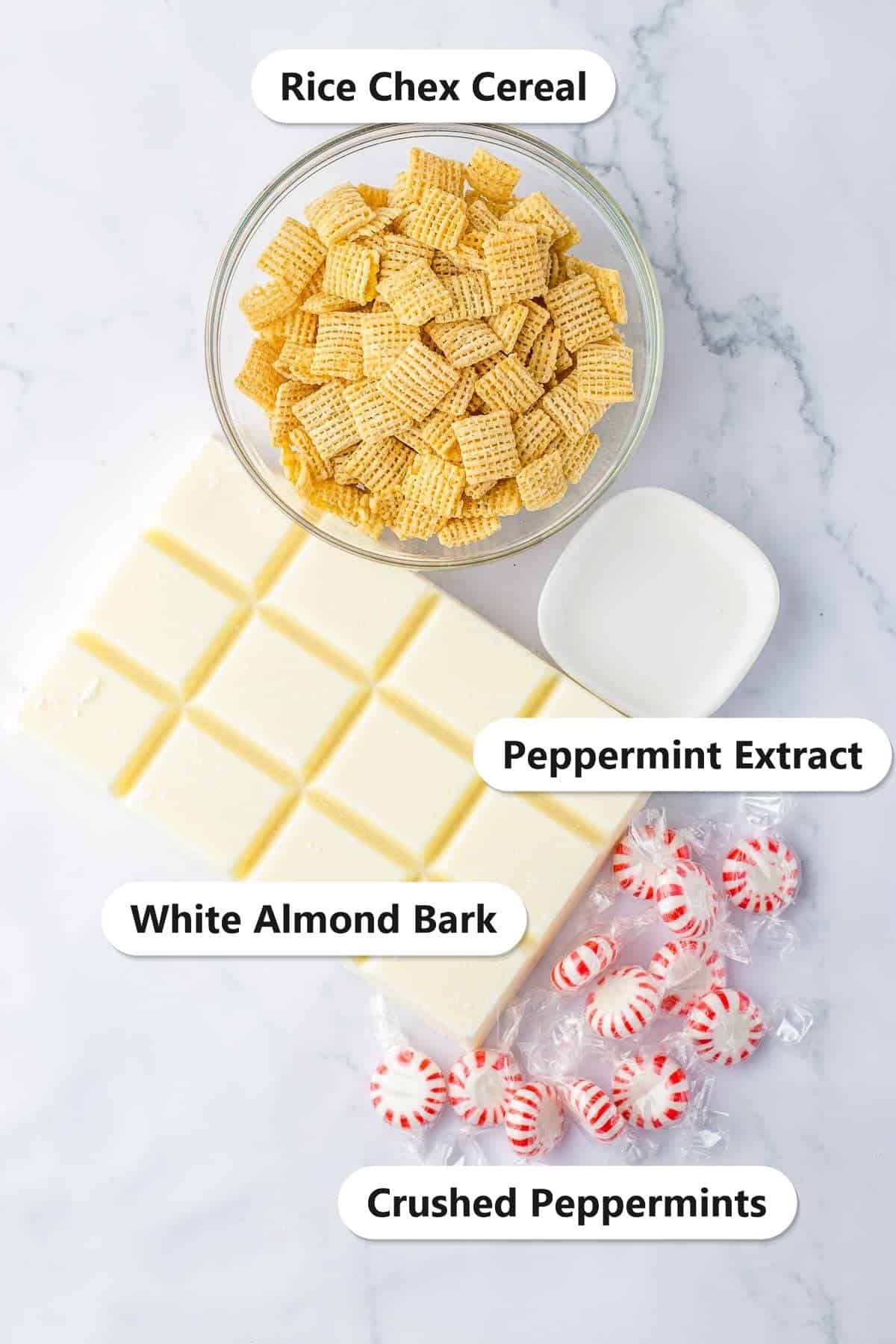 Labeled ingredients for white chocolate chex mix including rice chex cereal, white almond bark, peppermint extract, and crushed peppermints.