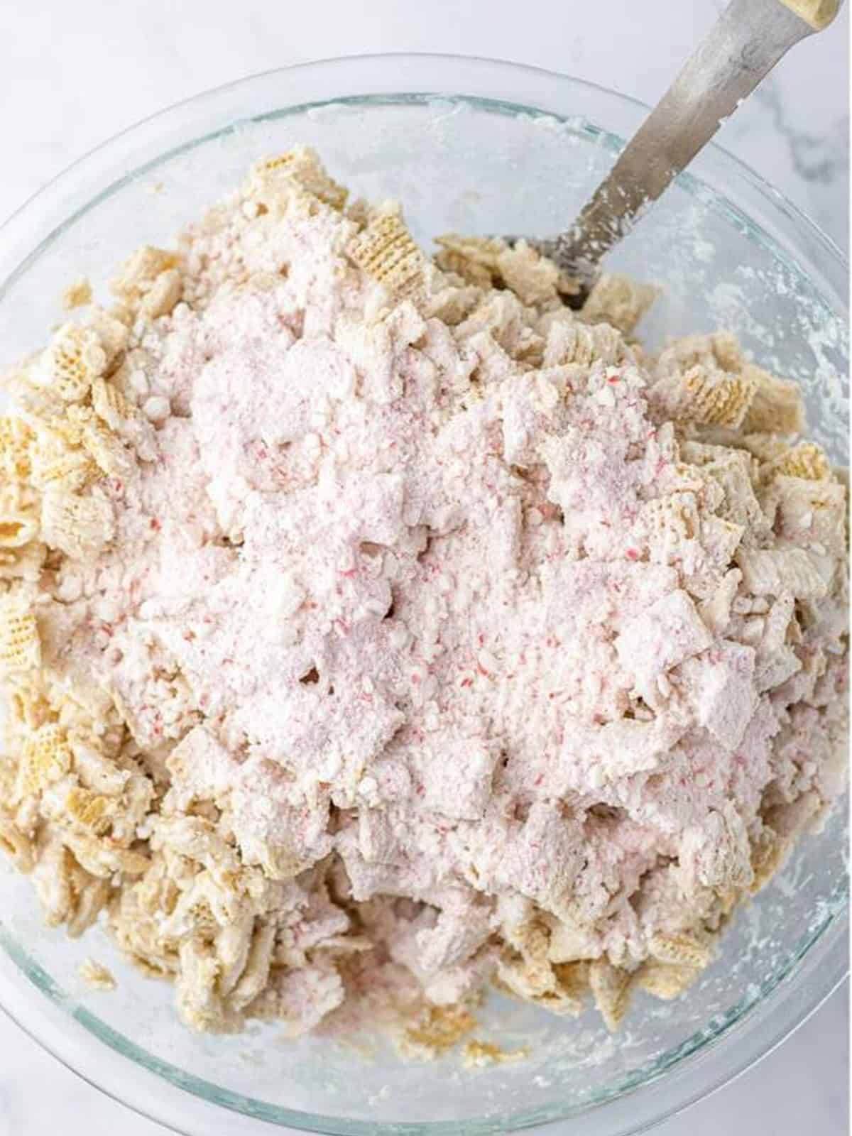 Crushed peppermints added to the white chocolate coated cereal for white chocolate chex mix.