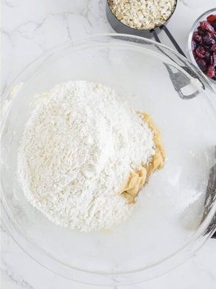 Flour, baking soda, and salt added to the White Chocolate Cranberry Cookies dough.