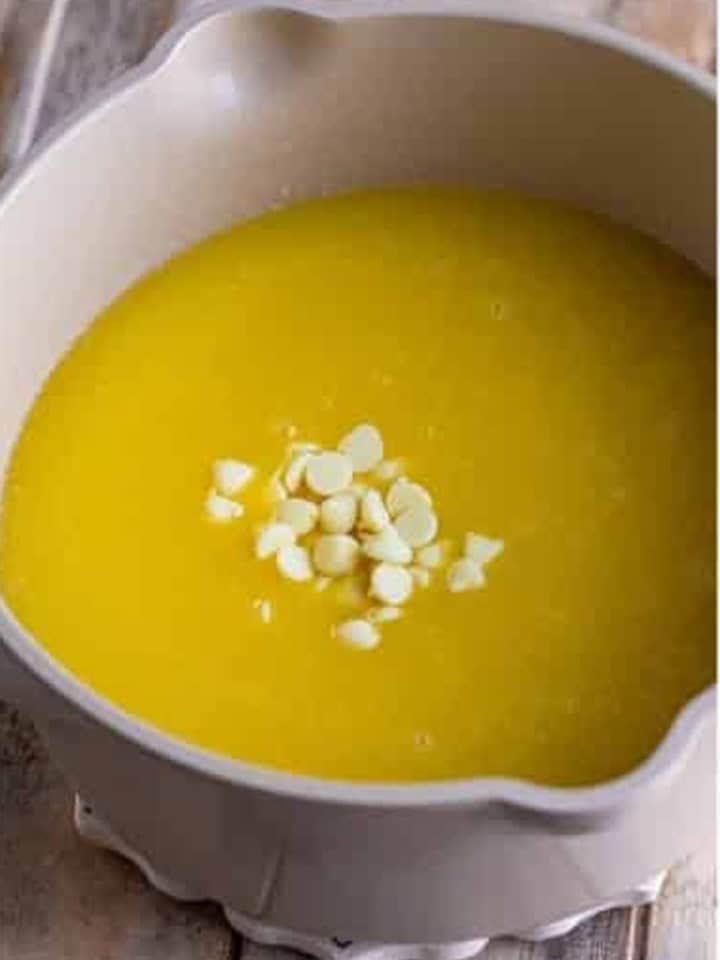 White chocolate chips added to the saucepan to melt into the sauce.