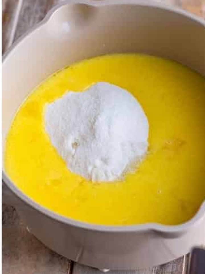 Sugar, white chocolate powder, and corn syrup added to the warm cream mixture.