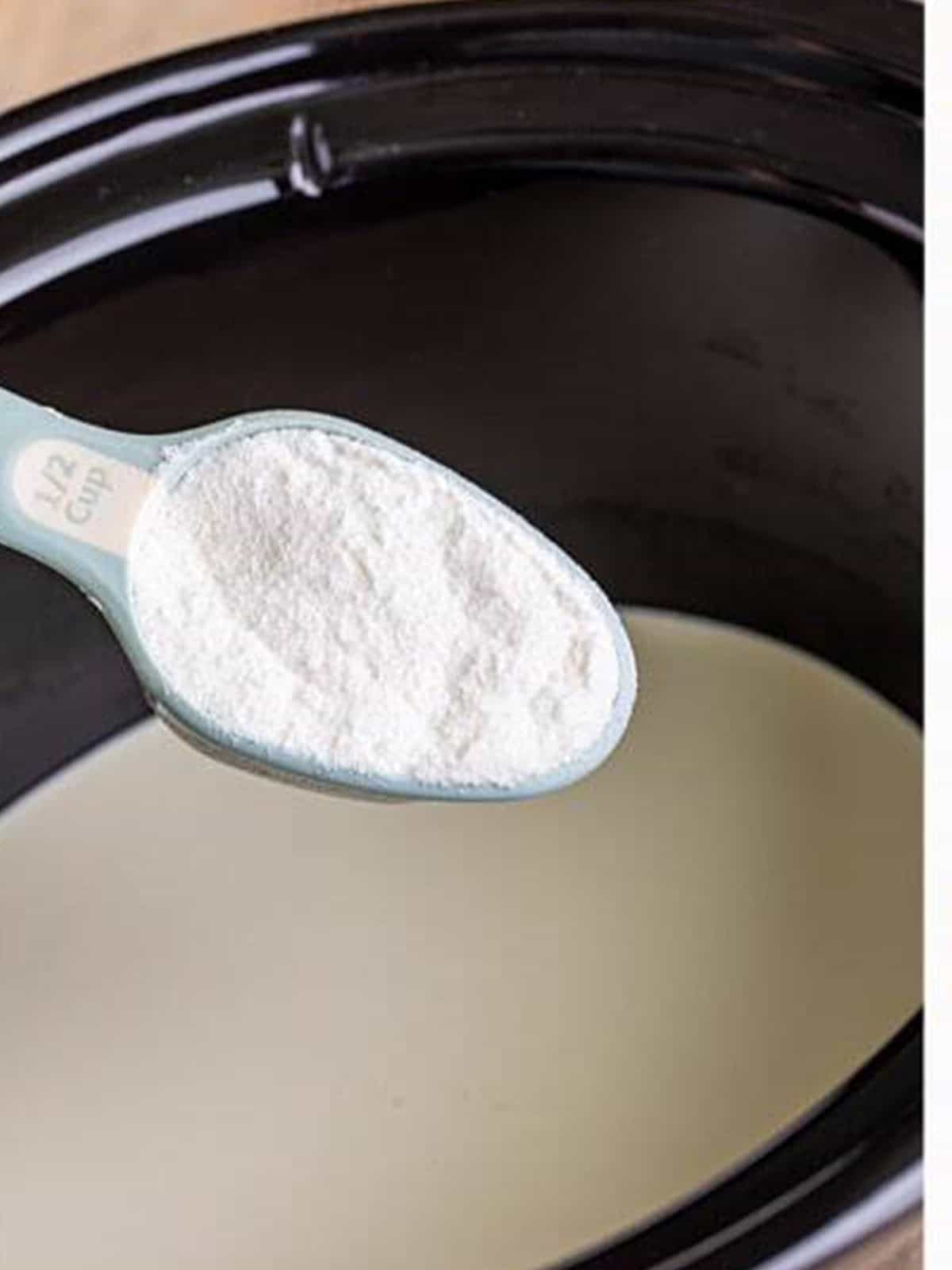 White chocolate powder added to heavy cream in the slow cooker for White Hot Chocolate.
