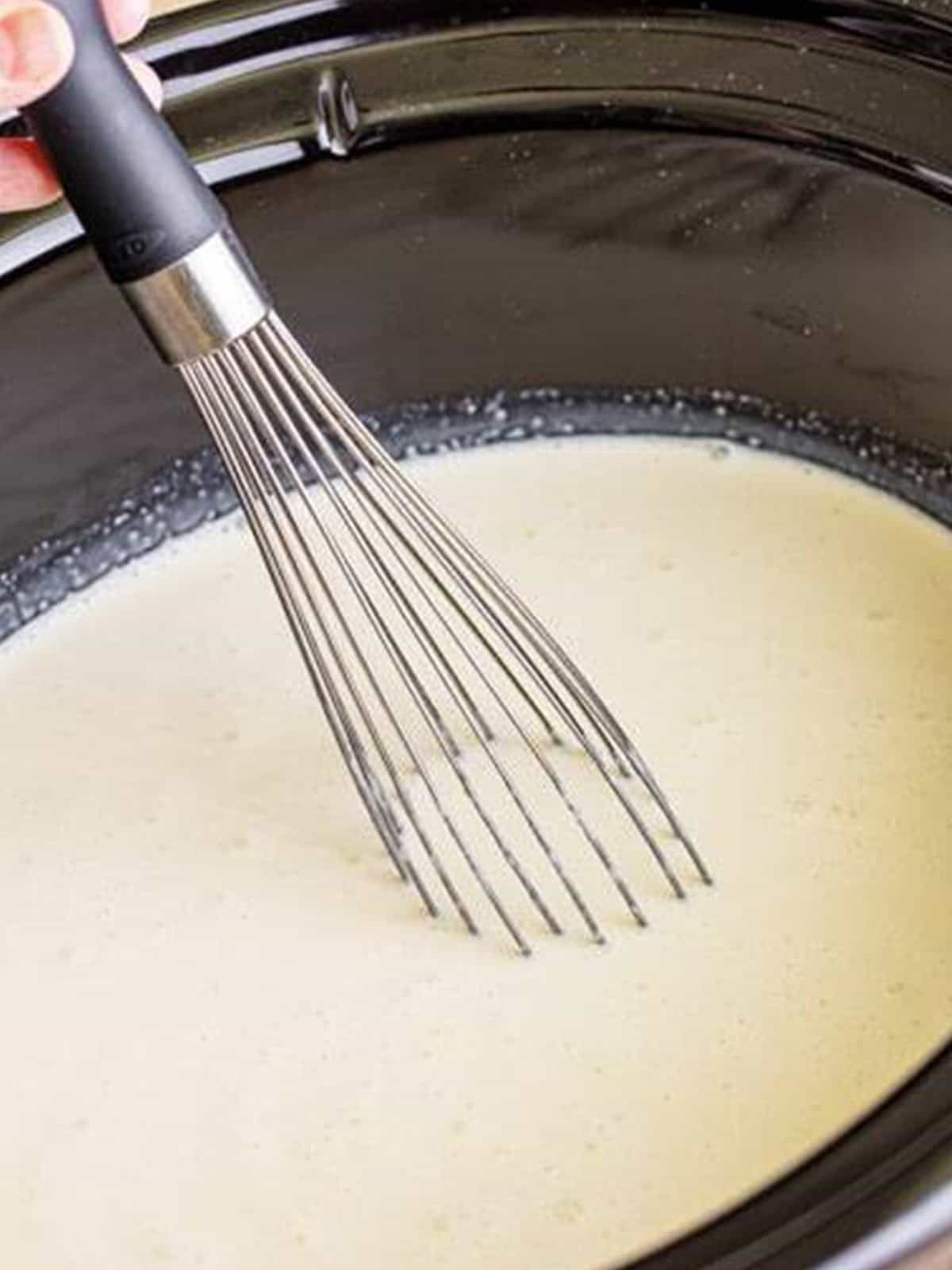 Whisking the White Hot Chocolate in the slow cooker until smooth and combined.