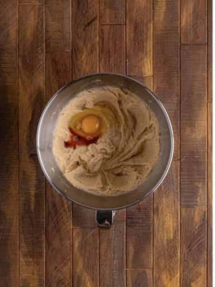 Egg added to creamed brown sugar, butter, and oil in a stand mixer bowl for Whoopie Pies batter.