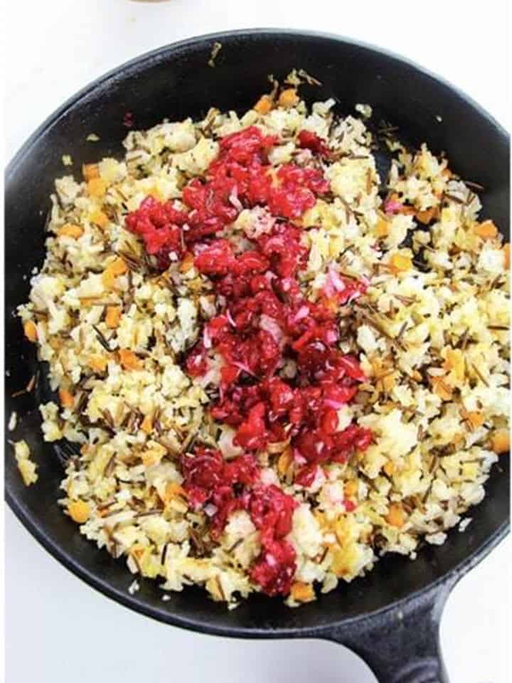 Adding minced cranberries and chopped pecans to the Wild Rice Pilaf.