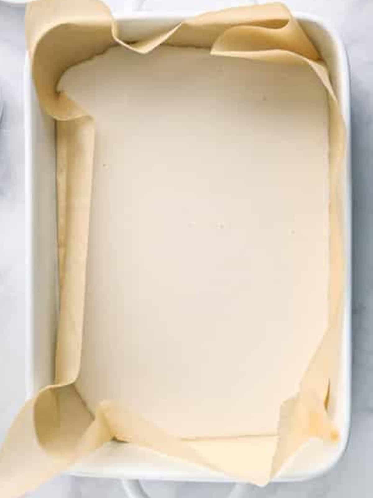 The yogurt mixture poured into a parchment lined baking dish and spread evenly.