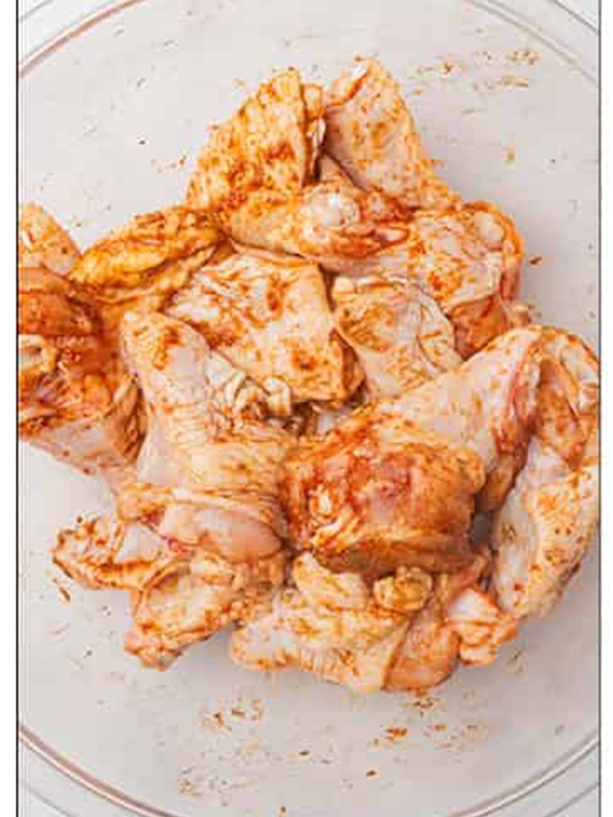 Chicken wings tossed until evenly coated in the dry seasoning mix.