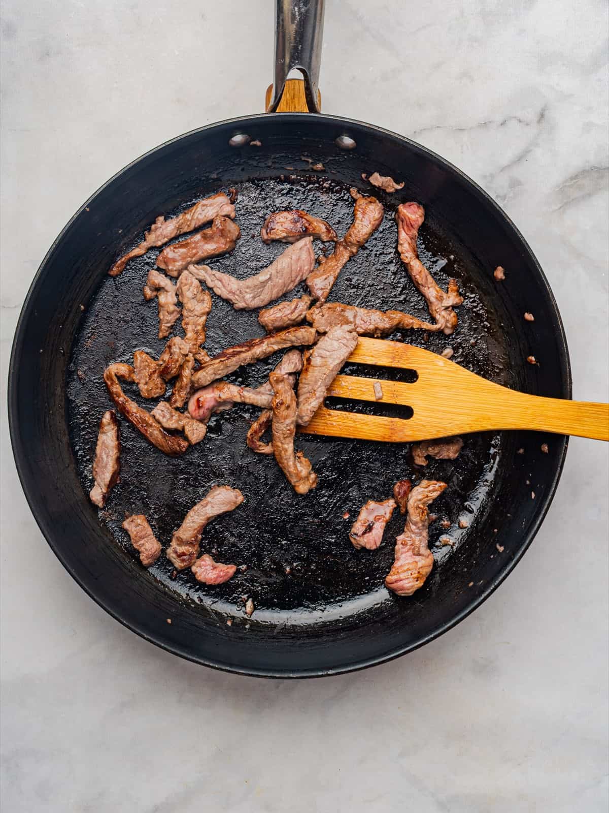 Sirloin strips seared until browned on the outside and ready to set aside.