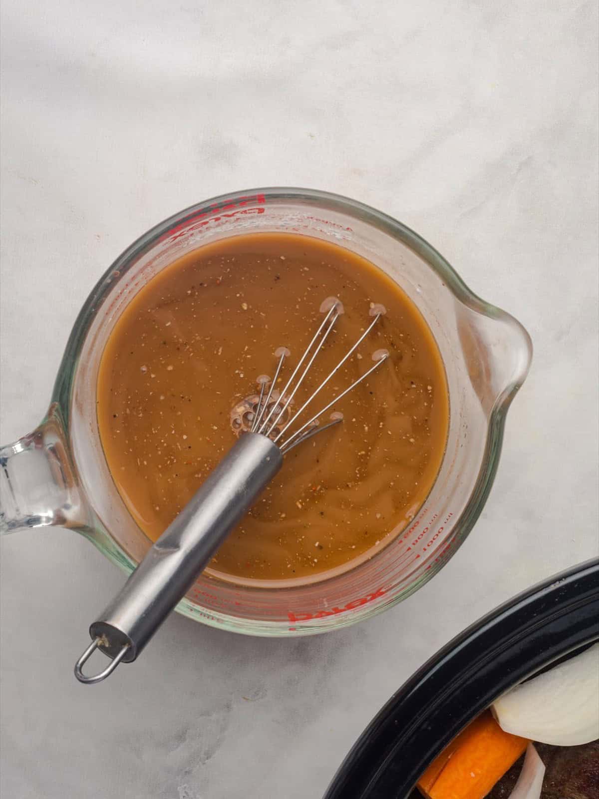 Beef broth, Worcestershire sauce and cornstarch whisked together in a glass measuring cup.